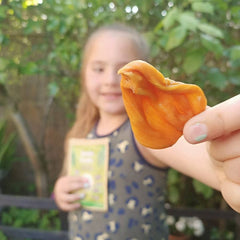 girl holding jackfruit 100% Natural Dried Fruit | Vegan Snacks